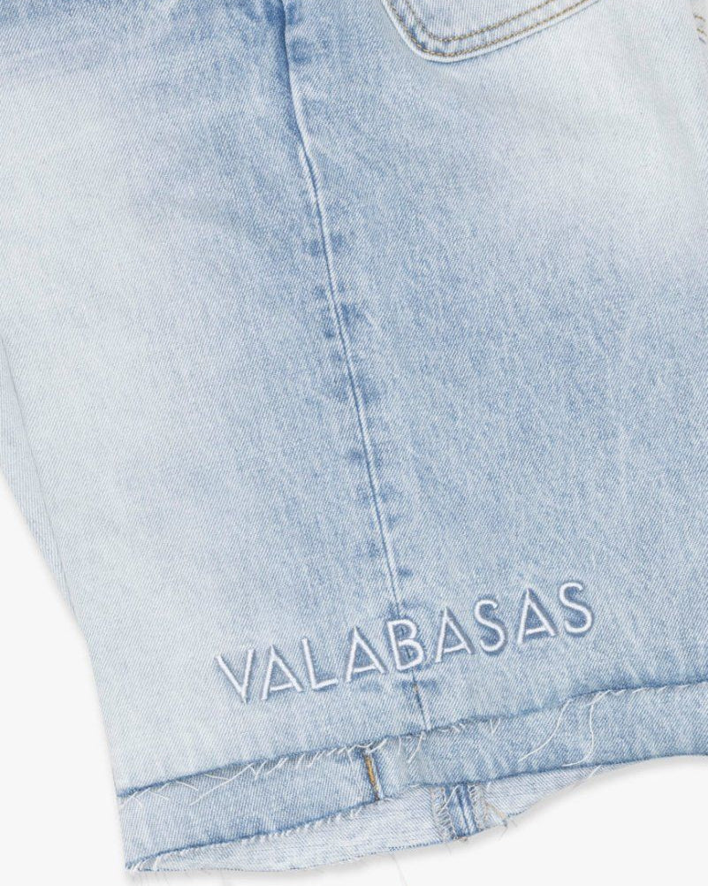 Light blue denim shorts with 'VALABASAS' branding on a white background