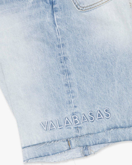 Light blue denim shorts with 'VALABASAS' branding on a white background