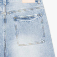 Light blue denim shorts with a brand label on a white background