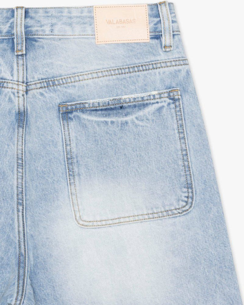 Light blue denim shorts with a brand label on a white background