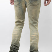 Person wearing light green distressed jeans on a white background