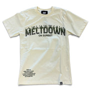 An beige short-sleeve t-shirt with a black graphic print reading 'MELTDOWN ON SUNSET' across the chest, featuring a flame-like 'M' and small black text details near the bottom hem.
