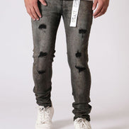 Person wearing distressed gray jeans with a white background