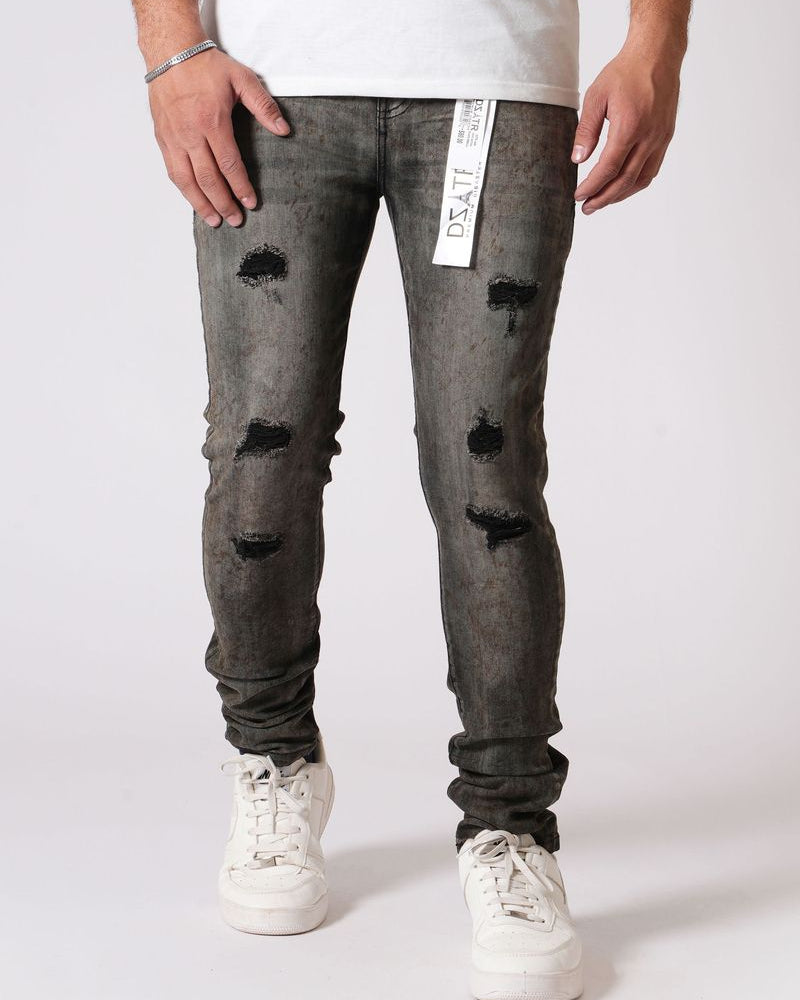 Person wearing distressed gray jeans with a white background
