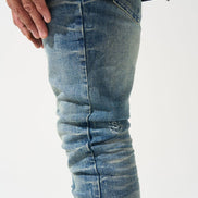 Close-up of blue jeans with a white background
