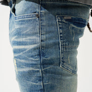 Close-up of blue jeans with a white background