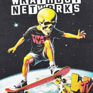 A stylized graphic print featuring a skull-faced figure in a black t-shirt and shorts riding a skateboard over a planet, with the large text 'WRATHBOY NETWORKS' at the top and a 'WTV' logo in the lower right.