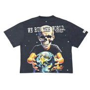 A black graphic t-shirt featuring a large print of a skull holding the Earth, with the text 'WE RUN THE WORLD.' across the chest and 'Winsteyer' printed below it.