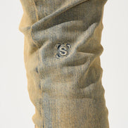 Close-up of beige pants with a logo on a white background