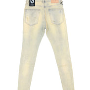 Back view of light-wash distressed skinny jeans with a black and white brand patch on the back waistband and a tan leather patch on the right side.