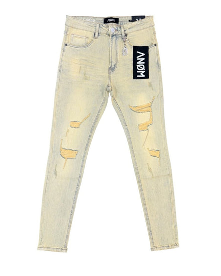 Light wash distressed skinny jeans with ripped details on the thighs and knees, featuring a black ANGM brand tag on the pocket.