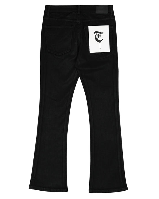 Black pants with a white label featuring a logo on a white background
