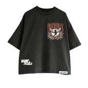 A black oversized short-sleeve t-shirt with a distressed graphic on the left chest featuring a bird and the text 'FREE REFILLS'. It has a small white graphic patch on the lower left sleeve and a white brand label on the lower right hem.