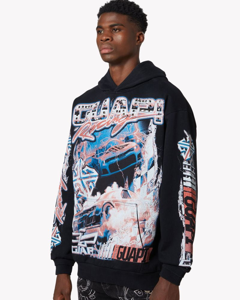 Person wearing a black hoodie with colorful graphic design on a white background