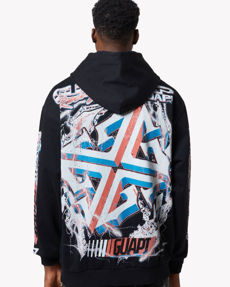 Person wearing a black hoodie with colorful geometric pattern on the back against a white background