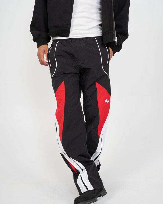 Black and red tracksuit with white accents on a plain background