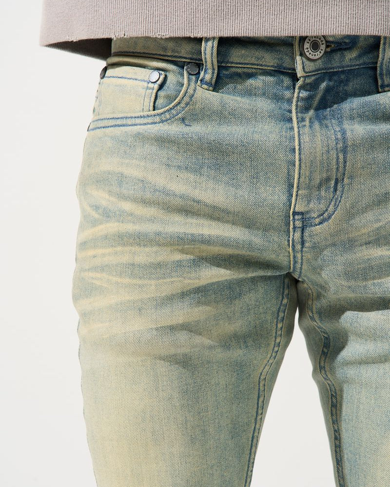 Close-up of light blue jeans on a white background