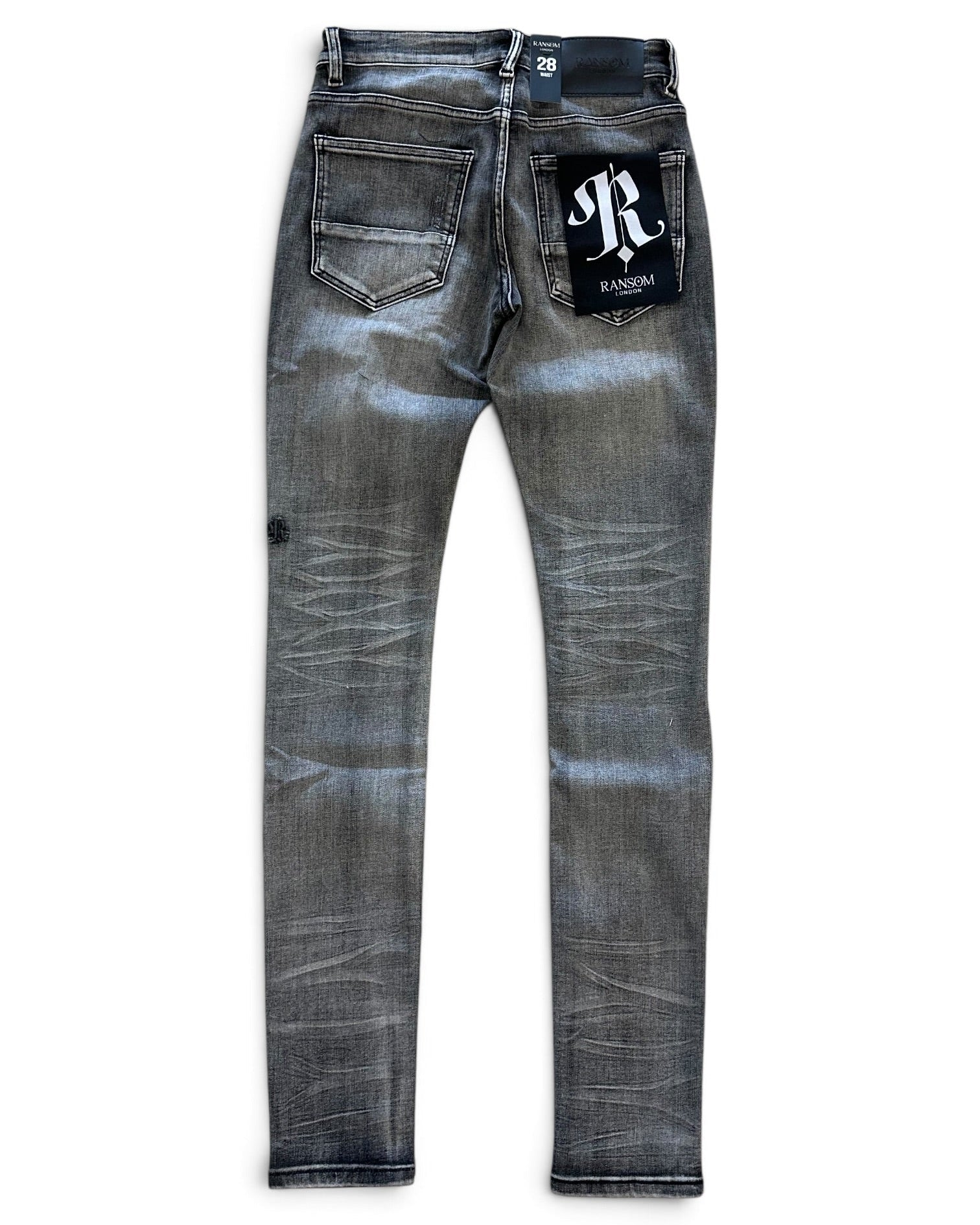 A pair of slim-fit denim jeans in a washed gray-blue wash, shown from the back on a white background. The back pocket features a black patch with a white 'R' logo and 'RAIDOMA' text, and a small black tag is visible on the left thigh.
