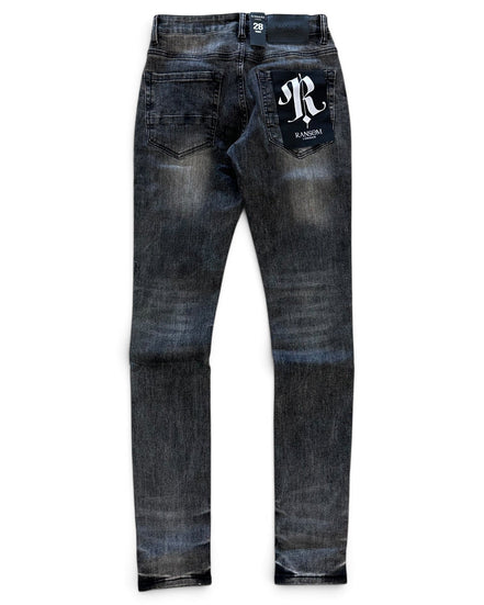 A pair of dark blue denim jeans with a faded wash, featuring a white embroidered 'R' logo patch on the back right pocket and a small white brand tag at the back waistband, shown against a plain white background.
