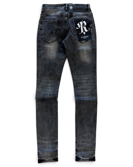 A pair of dark blue denim jeans with a faded wash, featuring a white embroidered 'R' logo patch on the back right pocket and a small white brand tag at the back waistband, shown against a plain white background.