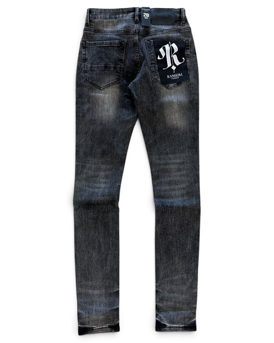 A pair of dark blue denim jeans with a faded wash, featuring a white embroidered 'R' logo patch on the back right pocket and a small white brand tag at the back waistband, shown against a plain white background.