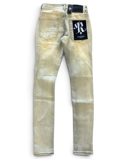 A pair of light beige acid-wash skinny jeans shown from the back, featuring a black brand patch with a white 'R' logo on the back right pocket and a matching black waistband label.