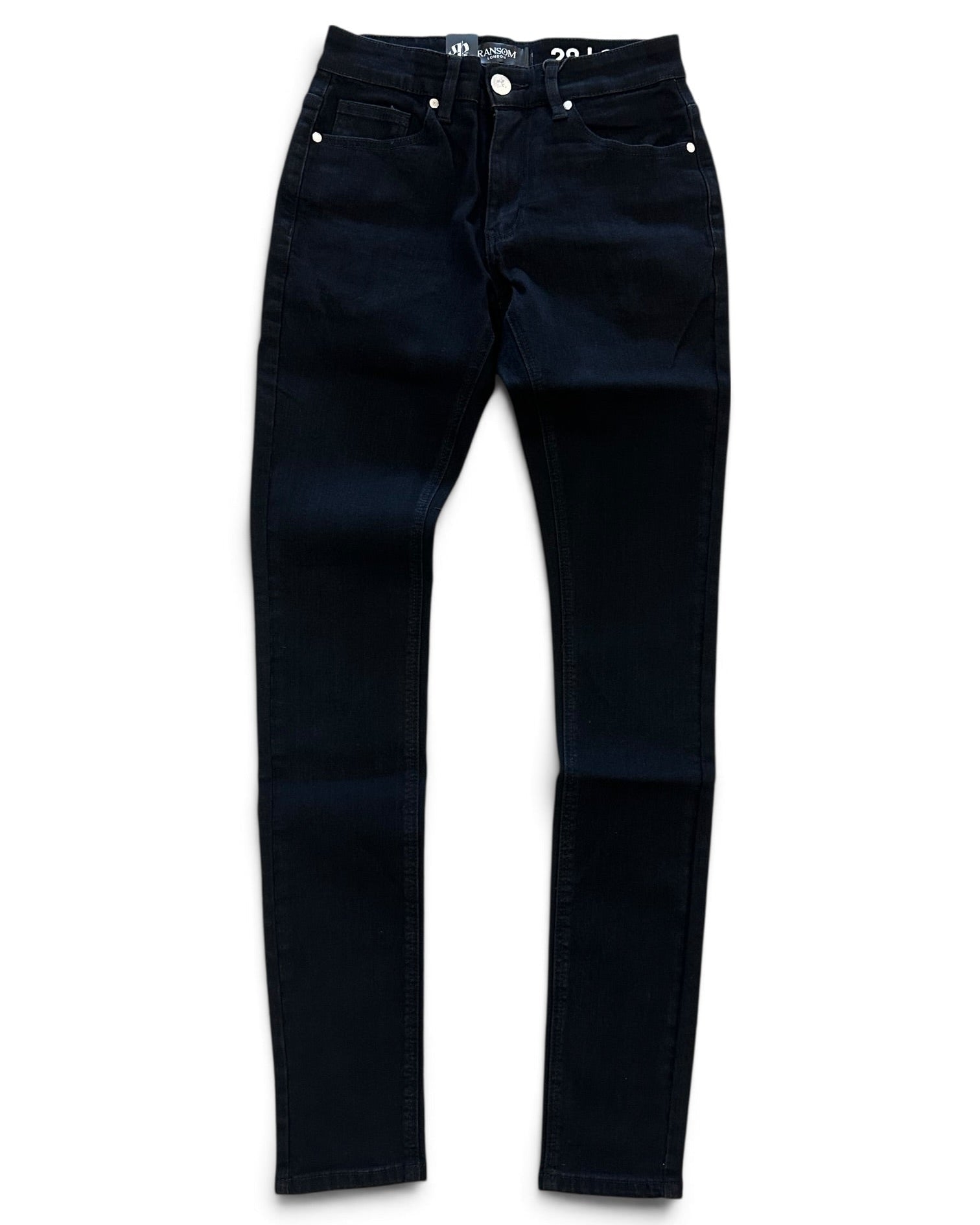 A pair of dark navy blue skinny jeans laid flat against a white background.
