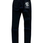 Dark navy blue slim-fit jeans shown from the back, featuring a white 'JR RANSOM' logo patch on the back pocket and a brand tag at the waistband, set against a plain white background.