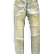 A pair of slim-fit jeans in a light beige or sand wash, laid flat against a white background.