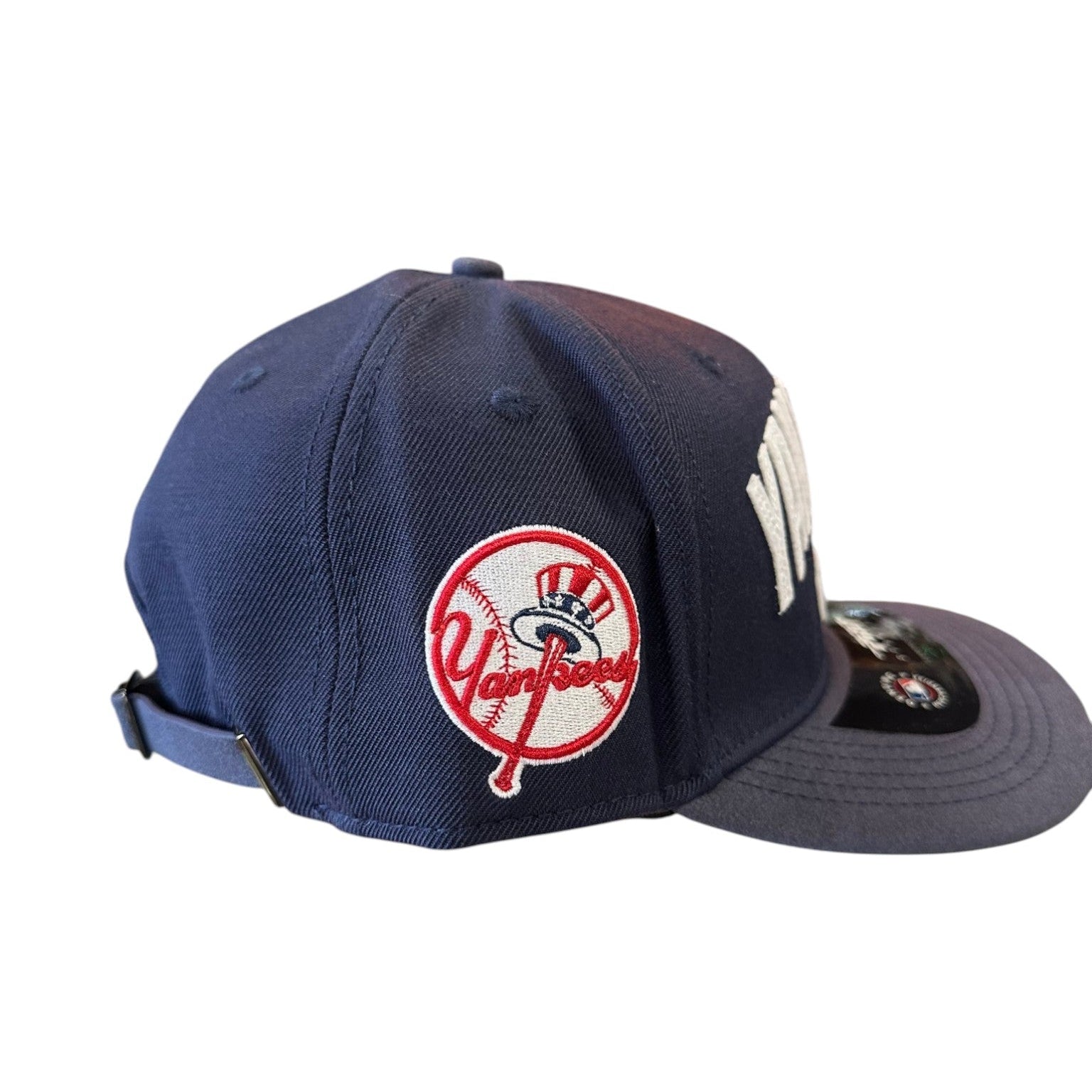 Navy blue baseball cap with a red and white logo on a white background