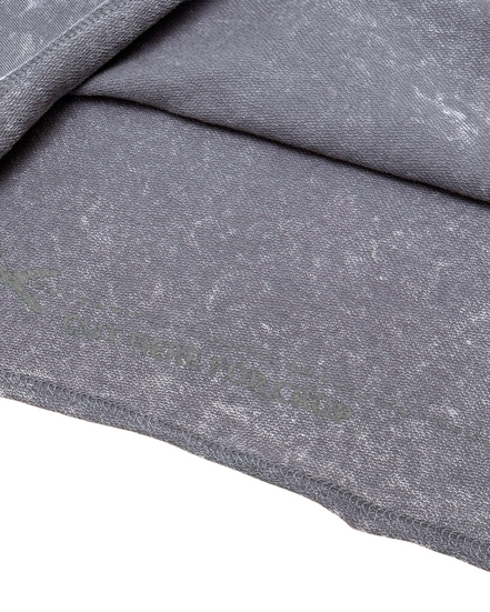 Close-up of gray fabric with a subtle pattern on a white background