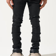 Person wearing black jeans and white sneakers on a white background
