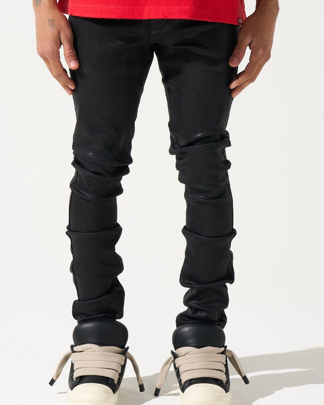 Person wearing black jeans and white sneakers on a white background