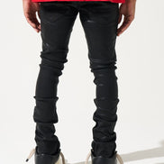 Person wearing black leather pants and red shirt on a white background
