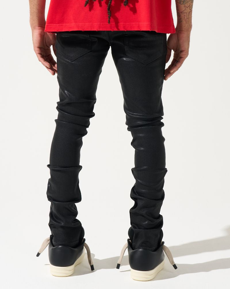 Person wearing black leather pants and red shirt on a white background