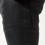 Black pants with a red shirt visible at the top on a white background