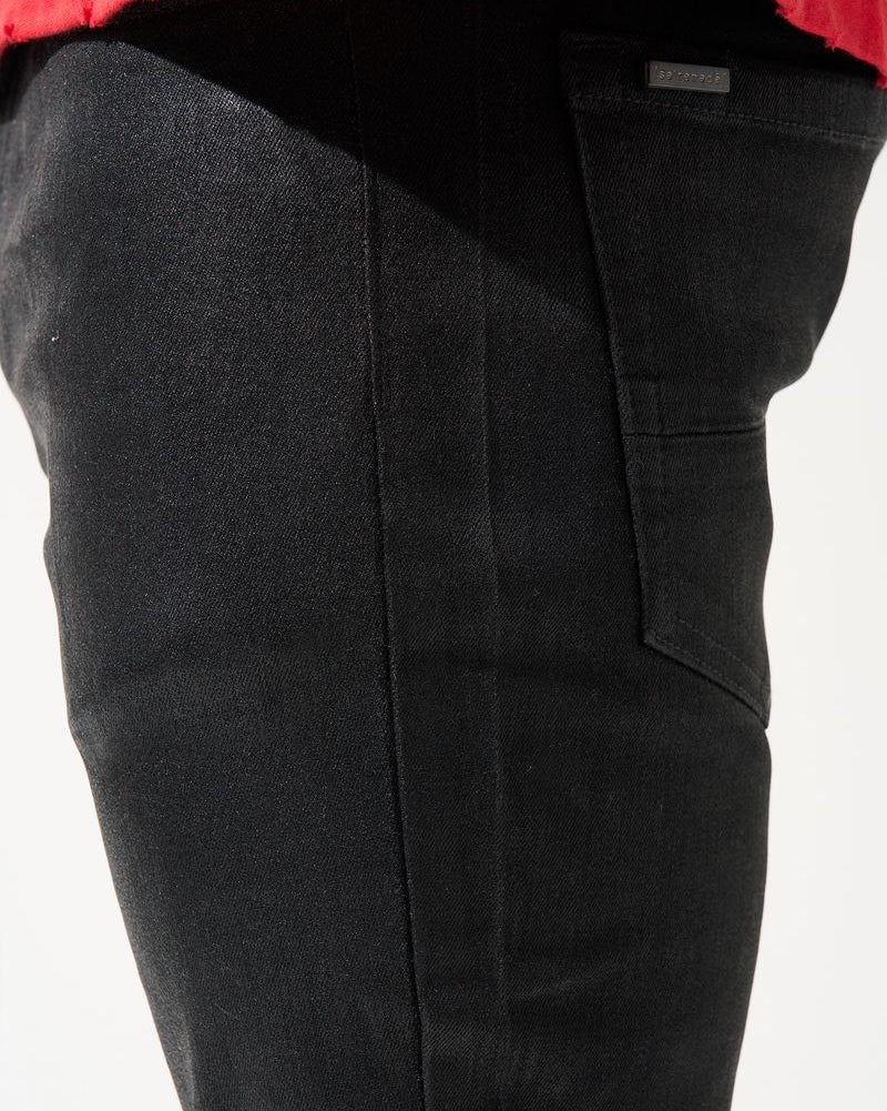 Black pants with a red shirt visible at the top on a white background