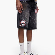 Person wearing a black denim skirt with patches, white socks, and white sneakers on a white background