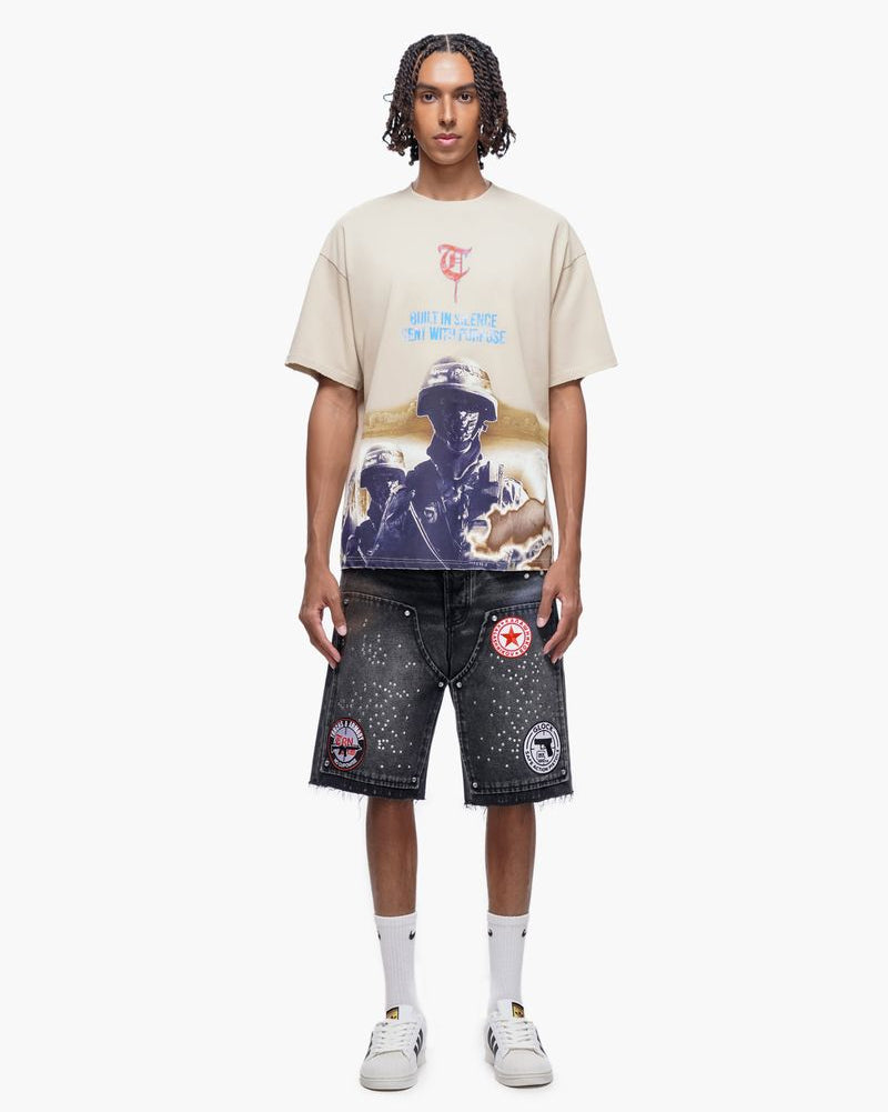 Person wearing a graphic t-shirt and shorts on a white background