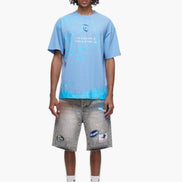 Person wearing a light blue t-shirt and gray shorts on a white background