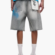 Person wearing gray denim shorts with a white logo on a white background