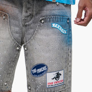 Gray denim shorts with brand patches on a white background