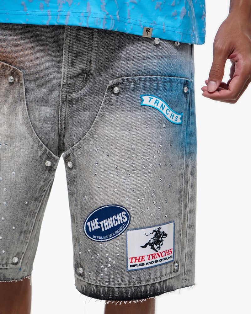 Gray denim shorts with brand patches on a white background
