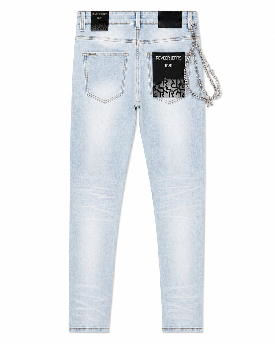 Light wash blue denim jeans shown from the back, featuring a black brand patch with a silver chain detail on the right pocket, on a plain white background.