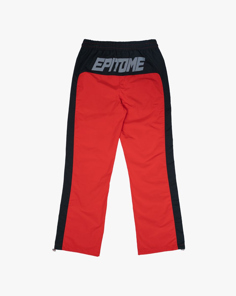 Red pants with black side panels and 'Epitome' branding on a white background