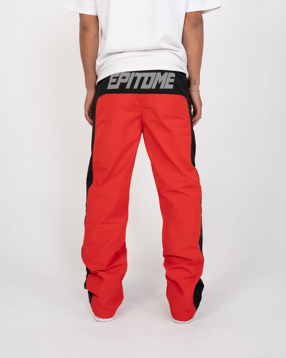 Red pants with black accents and 'EPITOME' branding on a white background