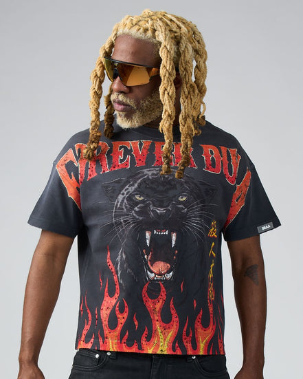 Man wearing a black t-shirt with a panther design and flames on a gray background