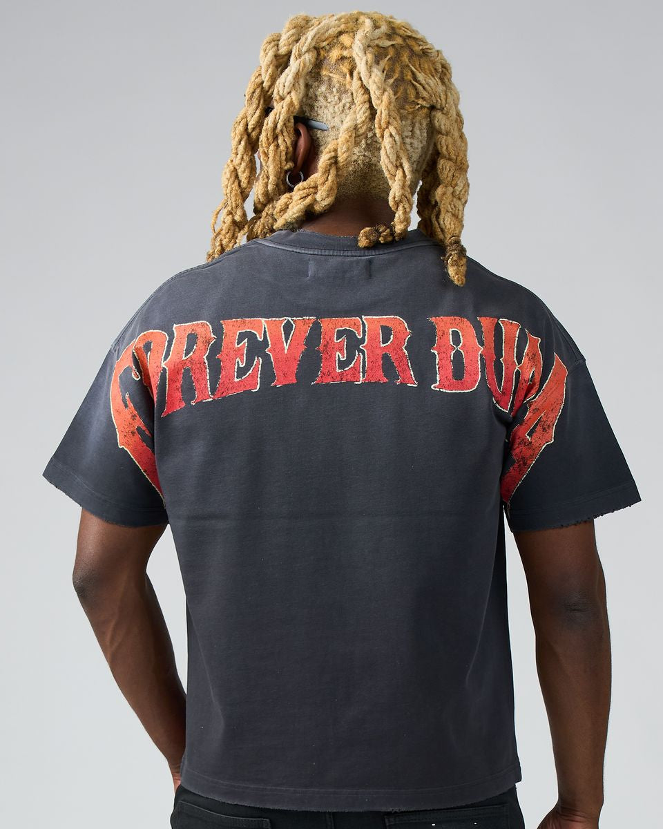 Person wearing a black t-shirt with red text on the back against a gray background