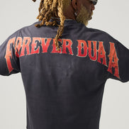 Person wearing a black shirt with 'FOREVER DUAA' printed on the back against a gray background