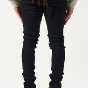 Person wearing black jeans and a light-colored top on a white background